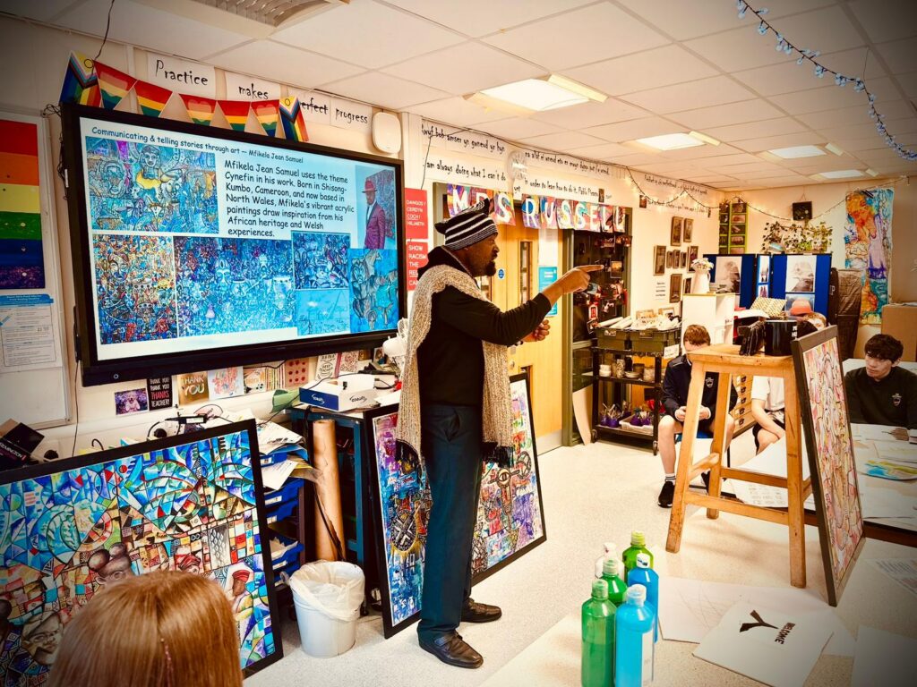 Mfikela Jean Samuel presenting artwork during a cultural and educational activity