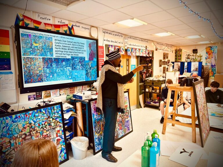 Mfikela Jean Samuel presenting artwork during a cultural and educational activity
