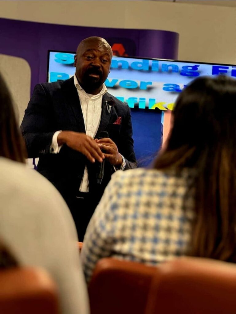 Jean Samuel speaking to an audience during a keynote presentation